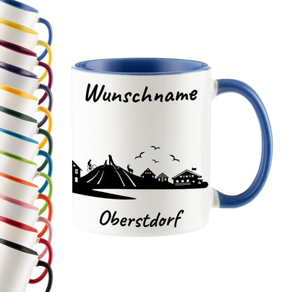 Tasse in Cambridge Blau 330ml bedruckt mit der Skyline von Oberstdorf personalisierbar mit Wunschname