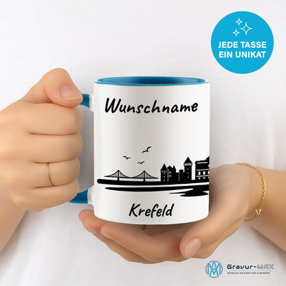Tasse in Hellblau 330ml bedruckt mit der Skyline von Krefeld personalisierbar mit Wunschname