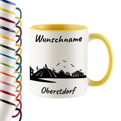 Tasse in Hellgelb 330ml bedruckt mit der Skyline von Oberstdorf personalisierbar mit Wunschname