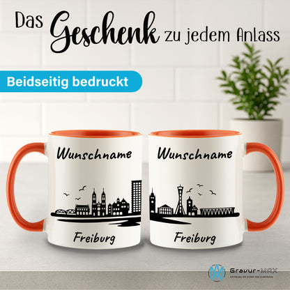 Tasse in Orange 330ml bedruckt mit der Skyline von Freiburg personalisierbar mit Wunschname