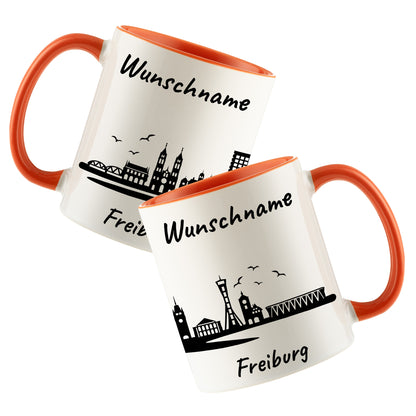 Tasse in Orange 330ml bedruckt mit der Skyline von Freiburg personalisierbar mit Wunschname